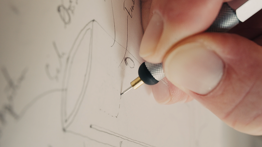 Hand sketching a concept with a mechanical pencil
